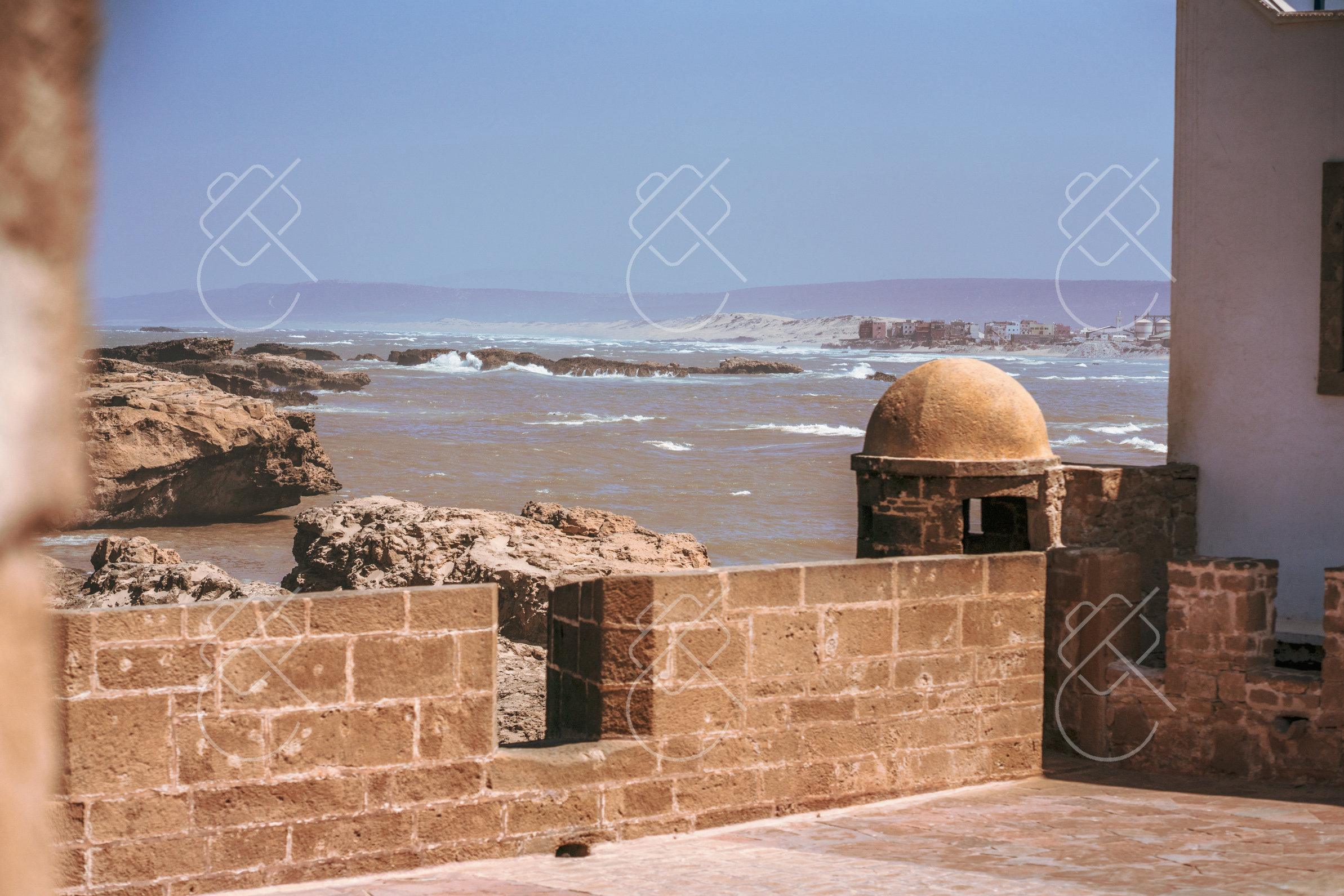 A domed lookout on the sea wall above the Atlantic rocks and surf — Essaouira, fine art travel photography print available from Clever Tourists