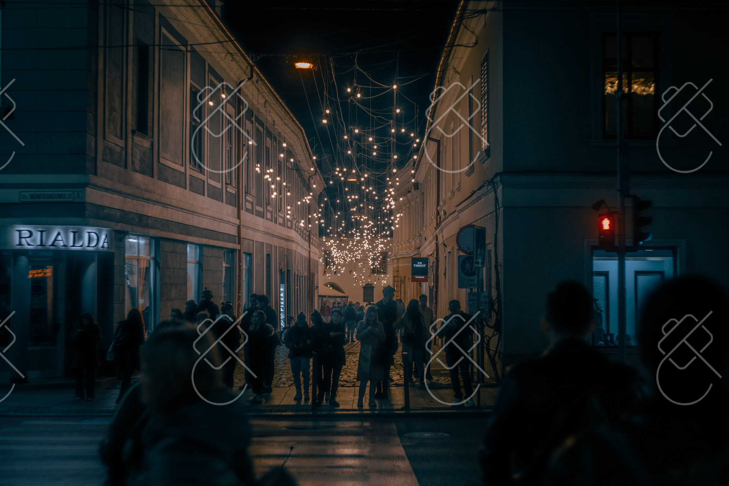 A crowded Cluj street at night under strings of lights — Cluj-Napoca