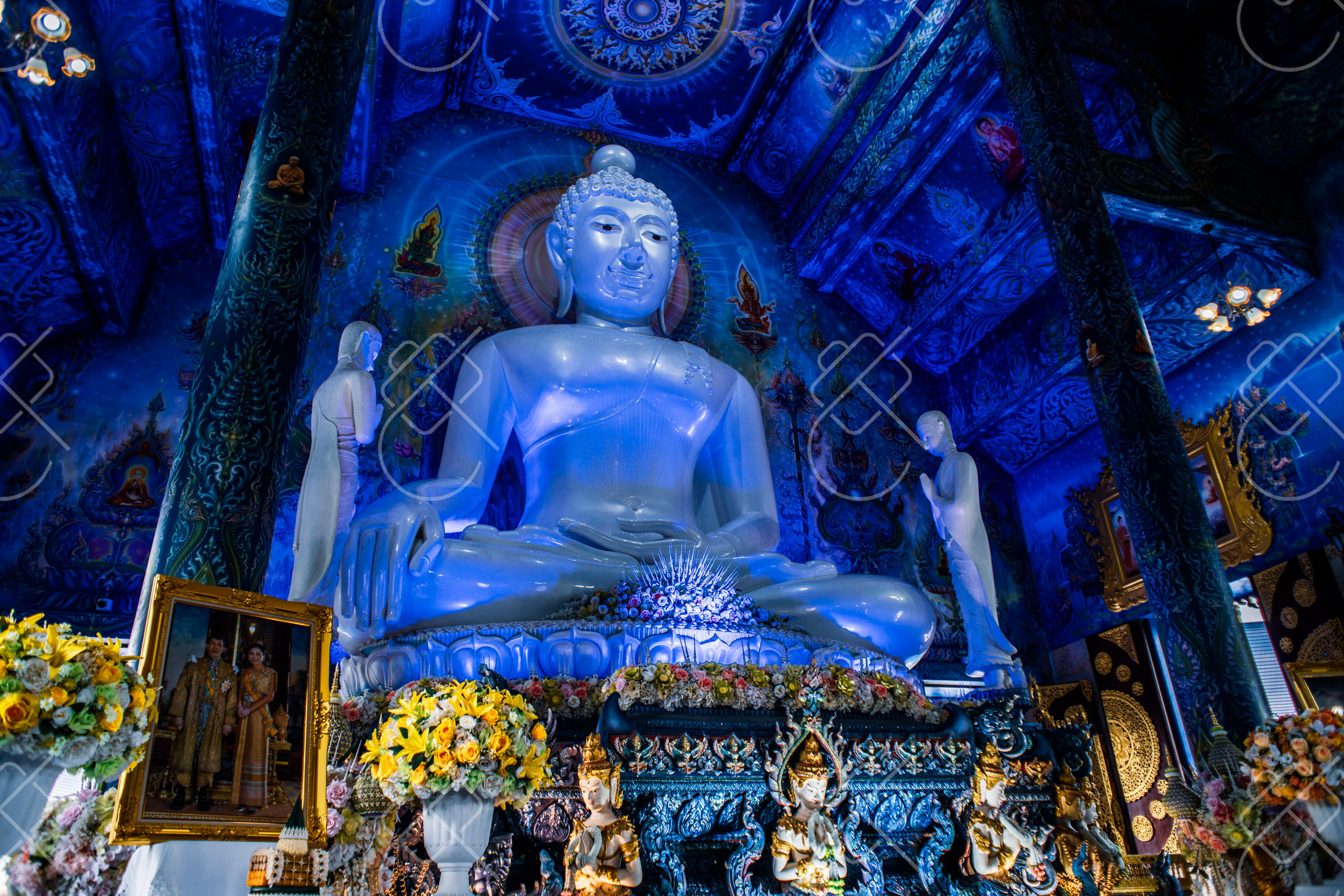 The white Buddha inside the deep-blue hall of Wat Rong Suea Ten, the Blue Temple — Chiang Rai, fine art travel photography print available from Clever Tourists
