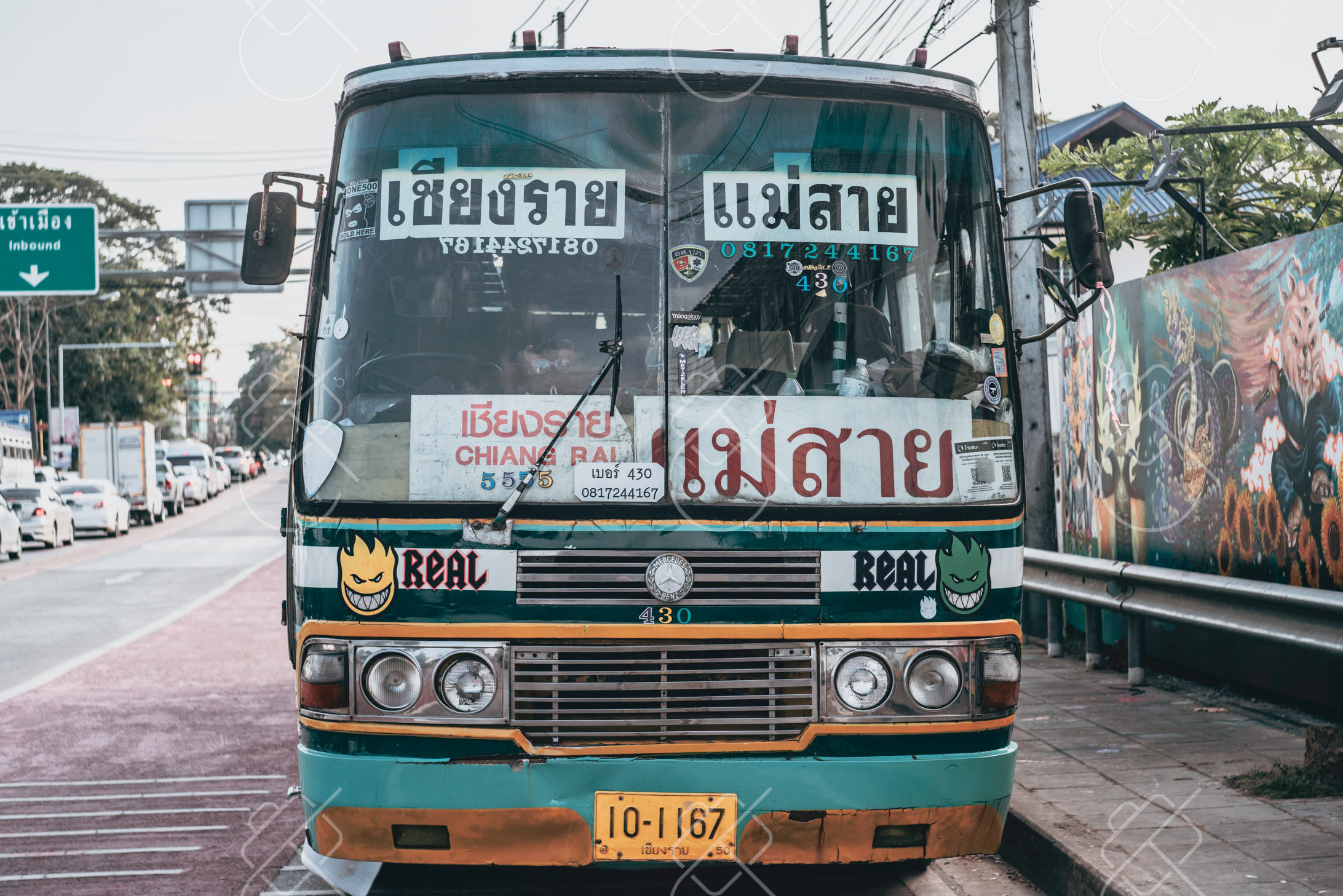 A green local bus signed Chiang Rai to Mae Sai, the Myanmar border crossing an hour and a half north — Chiang Rai, fine art travel photography print available from Clever Tourists
