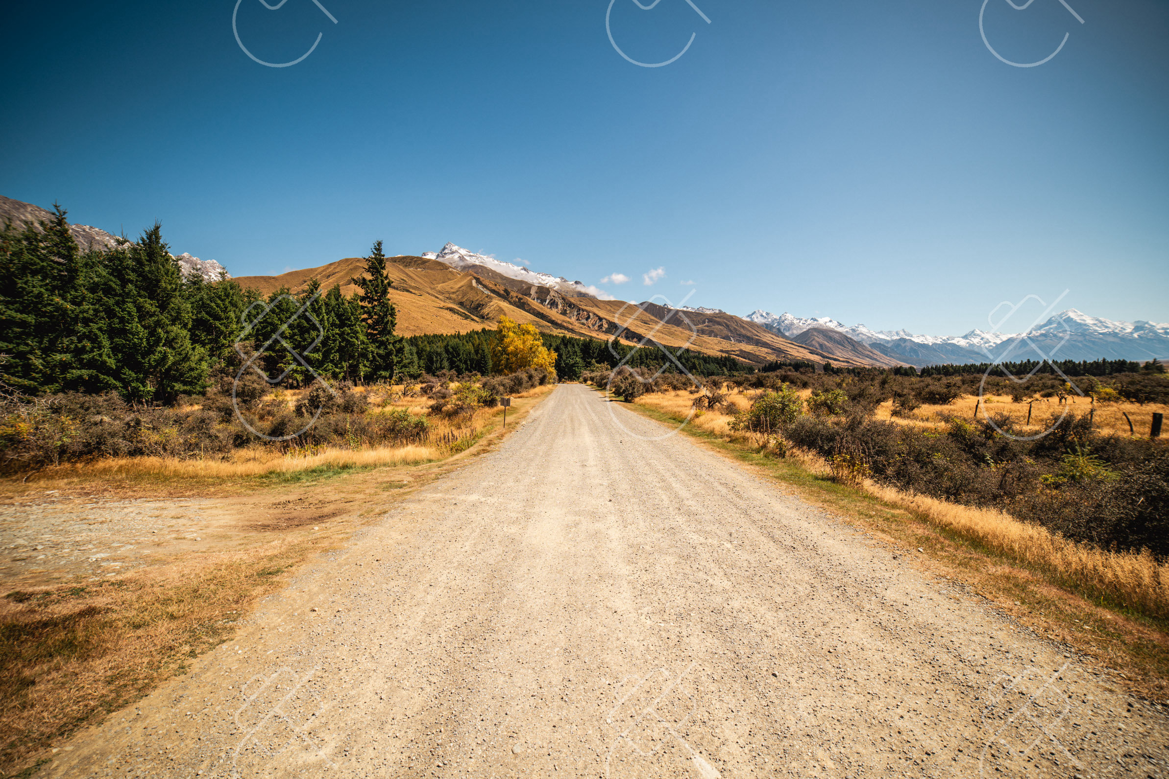 The gravel road leading into the majestic Mackenzie Basin and Southern Alps — Lake Pukaki, fine art travel photography print available from Clever Tourists