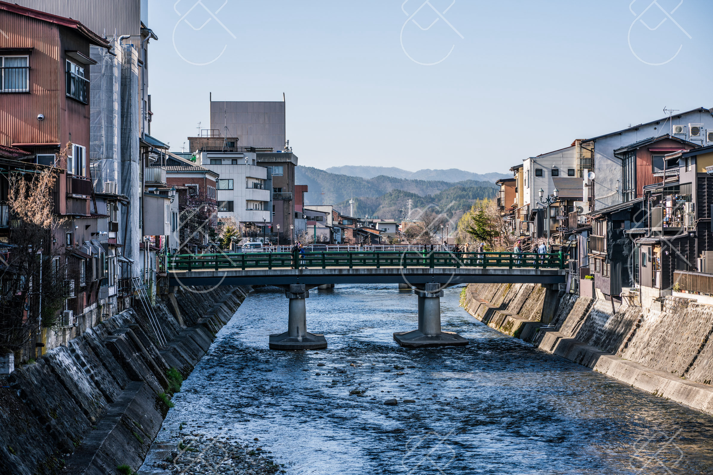 A footbridge over the Miyagawa River, with the Hida mountains beyond the town — Takayama, fine art travel photography print available from Clever Tourists