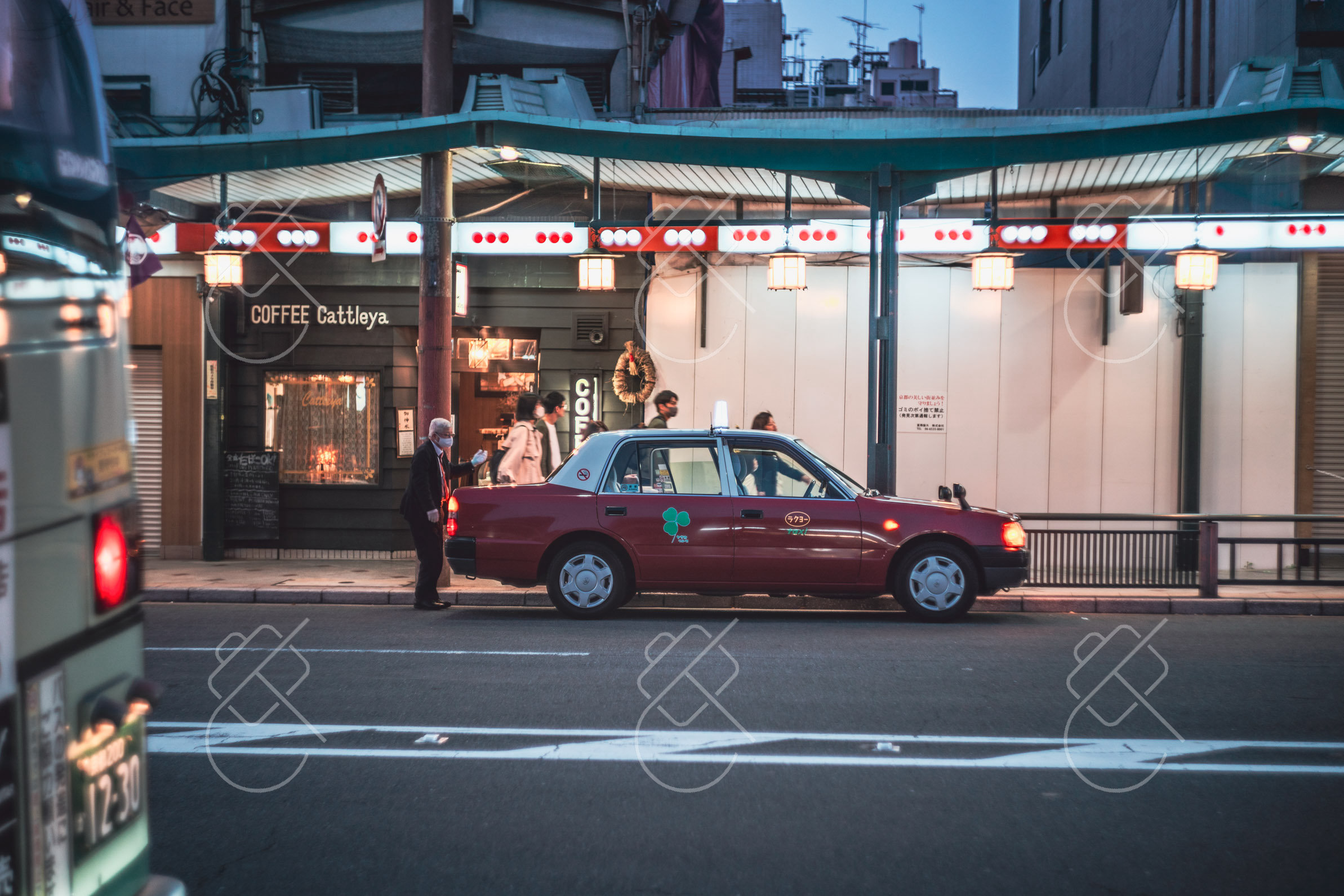 A taxi waiting outside a café in Kyoto, where a short cab ride often beats a packed city bus
