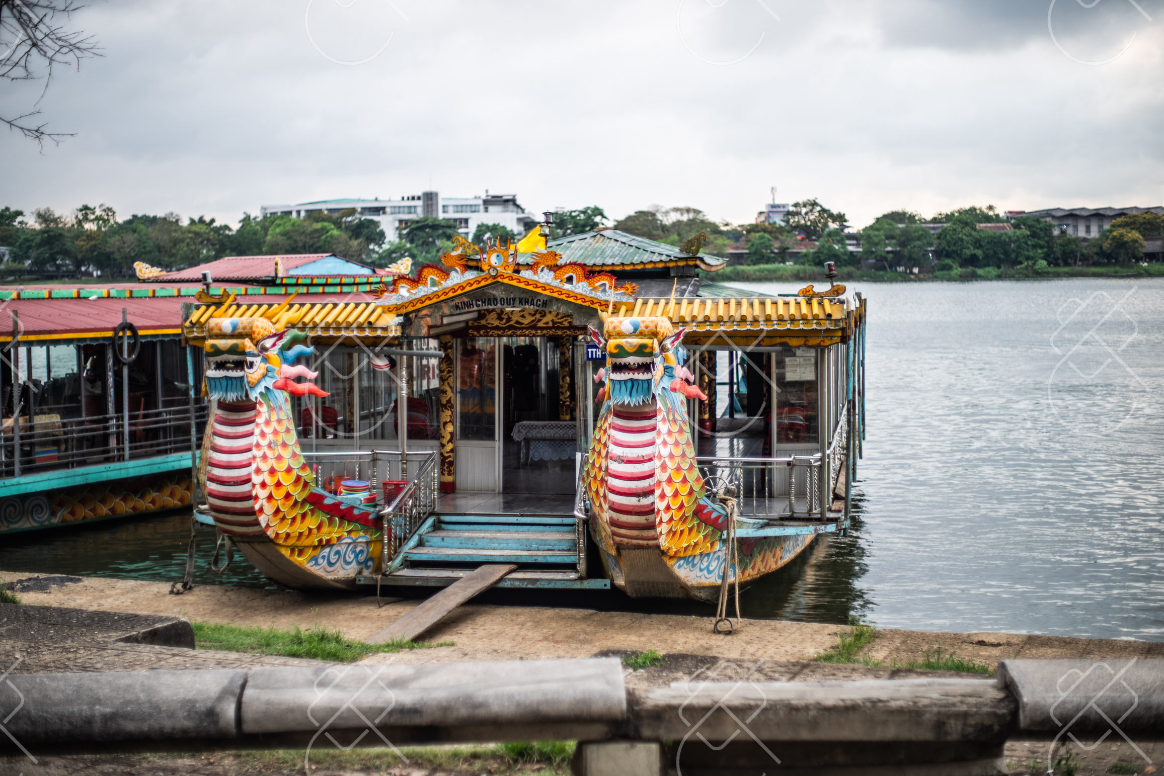 A dragon-prowed tourist boat moored on the Perfume River — Hue, fine art travel photography print available from Clever Tourists