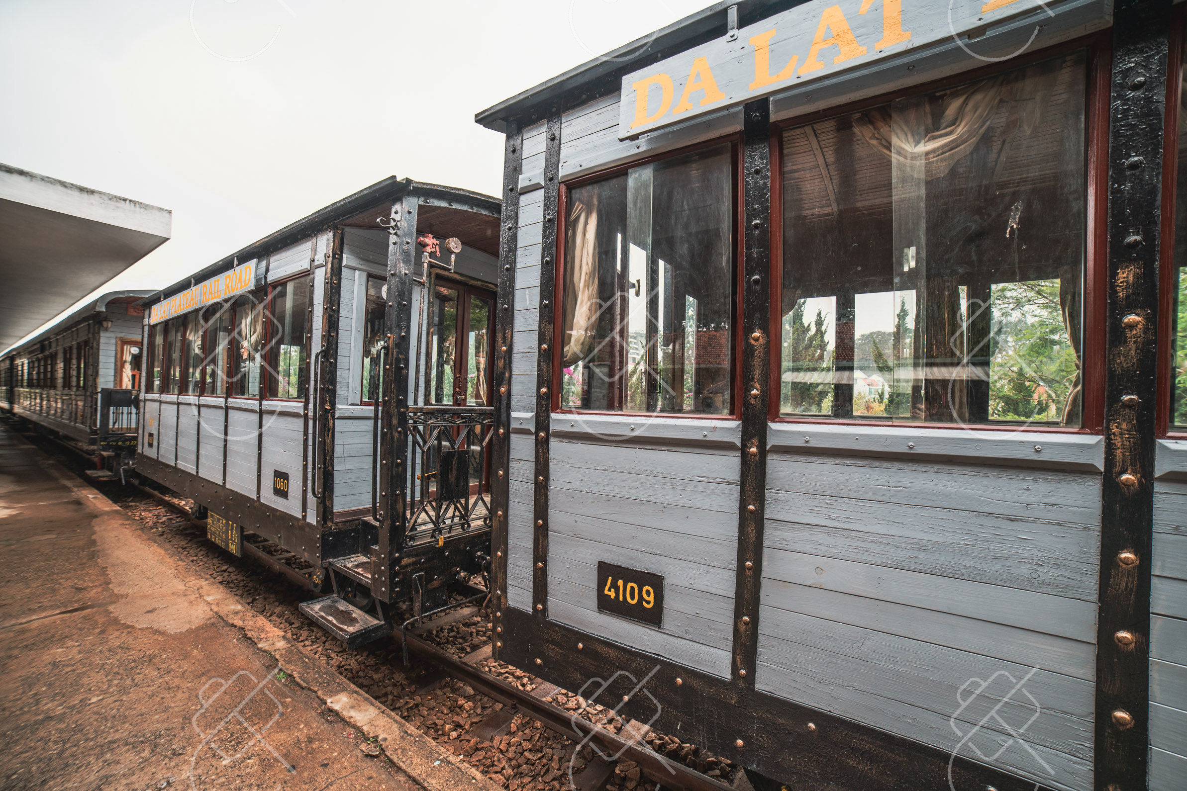 Restored wooden carriages of the Da Lat train waiting at the platform — Da Lat, fine art travel photography print available from Clever Tourists