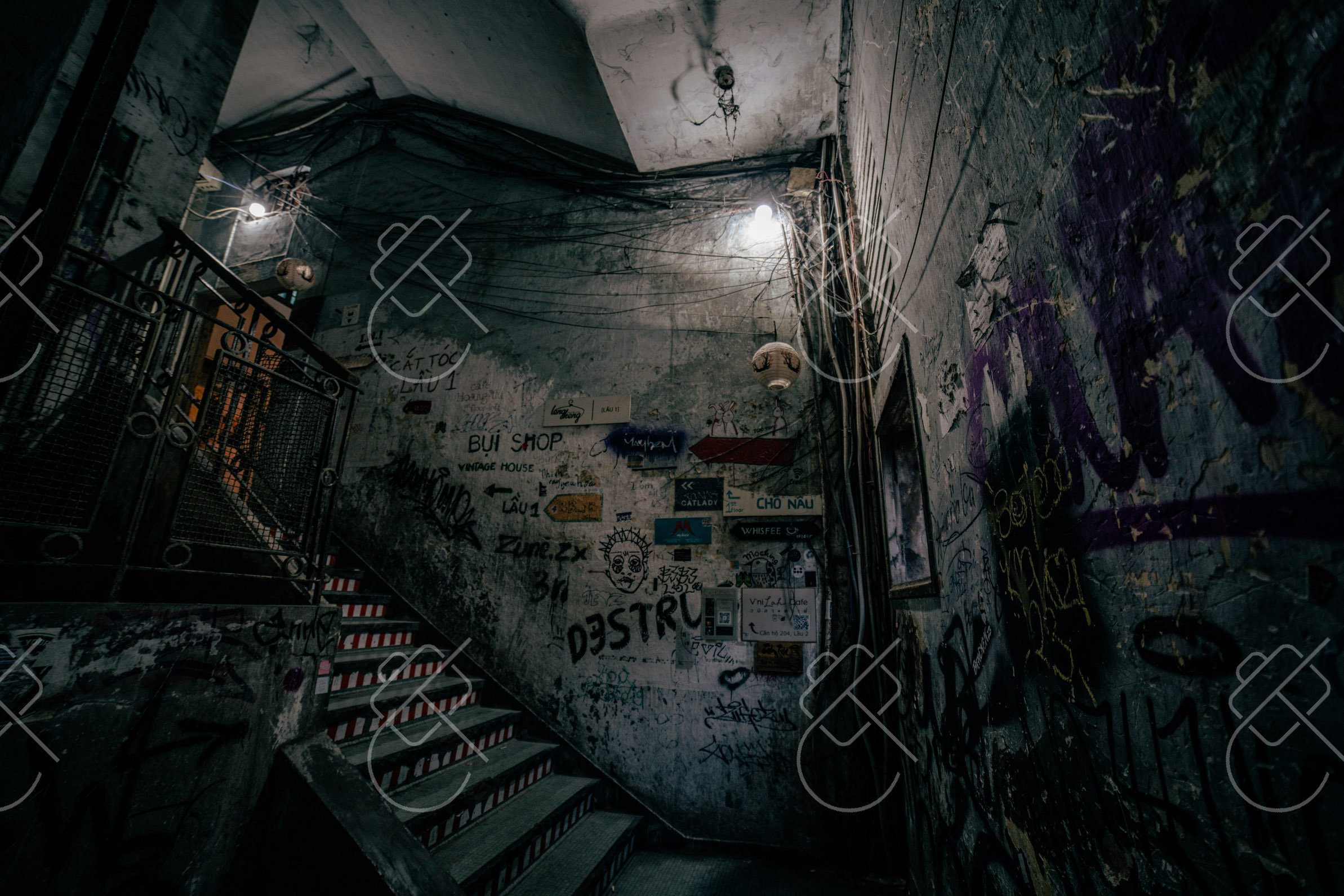 A graffiti-covered stairwell inside one of central Saigon's old apartment blocks — Ho Chi Minh City, fine art travel photography print available from Clever Tourists