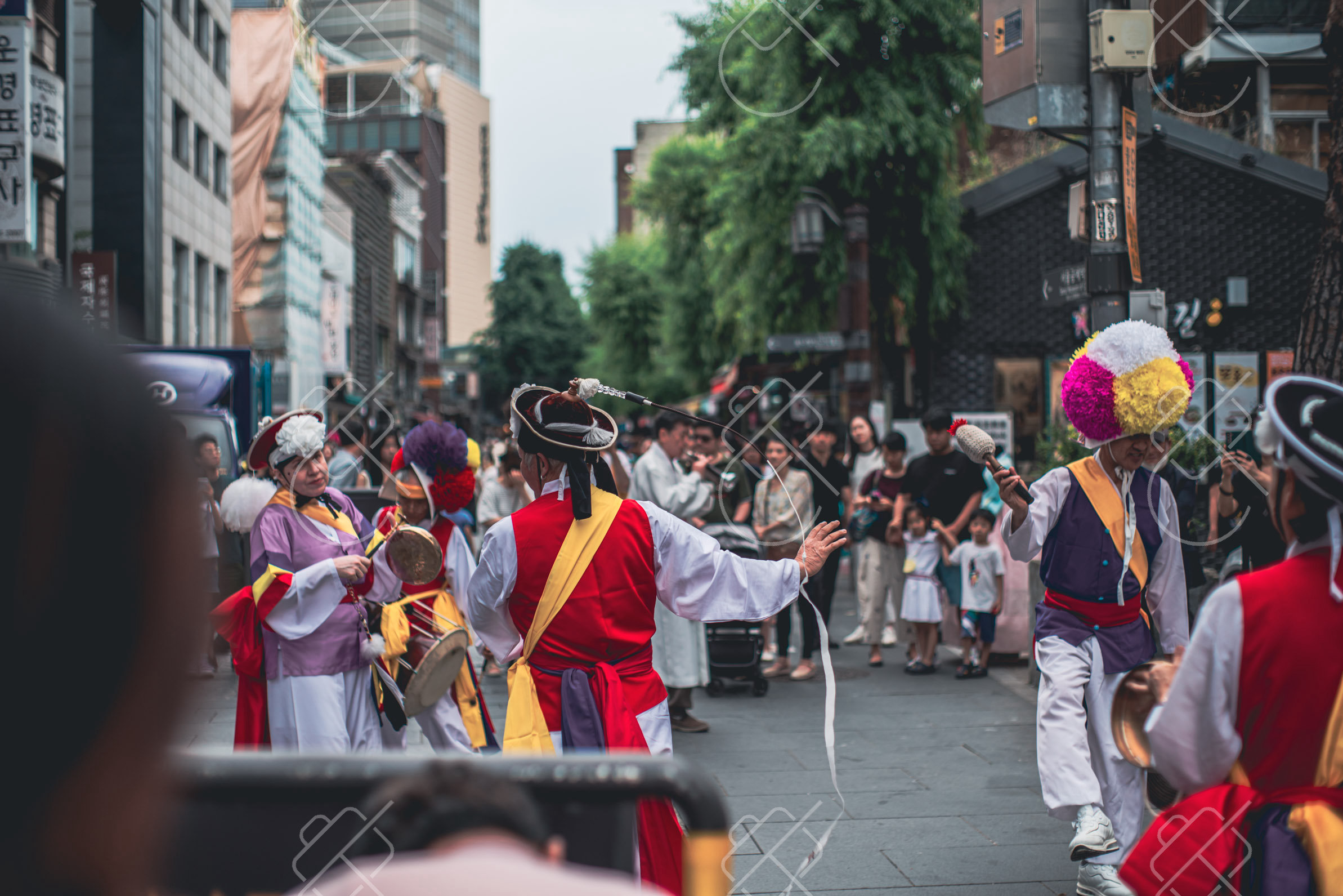 Performers in traditional dress on a Seoul street in June 2023