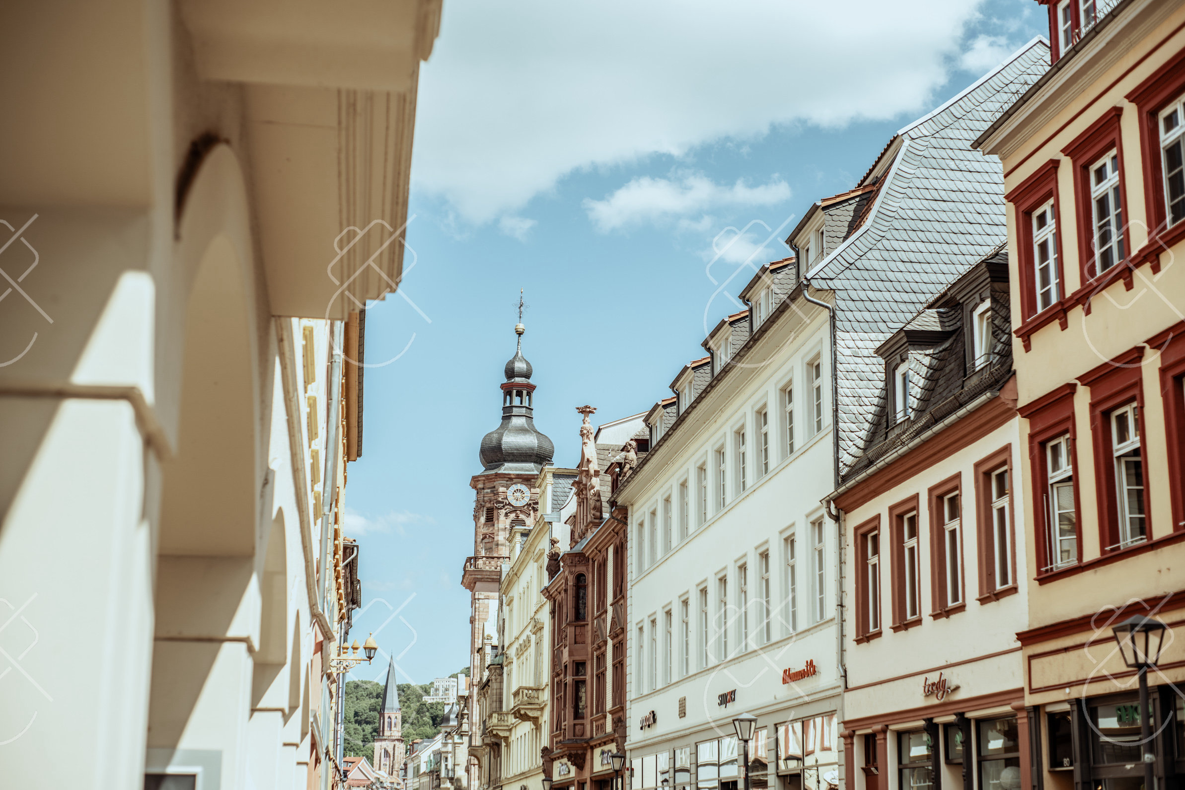The Hauptstraße's baroque townhouses lead the eye toward the Church of the Holy Spirit's tower — Heidelberg, fine art travel photography print available from Clever Tourists
