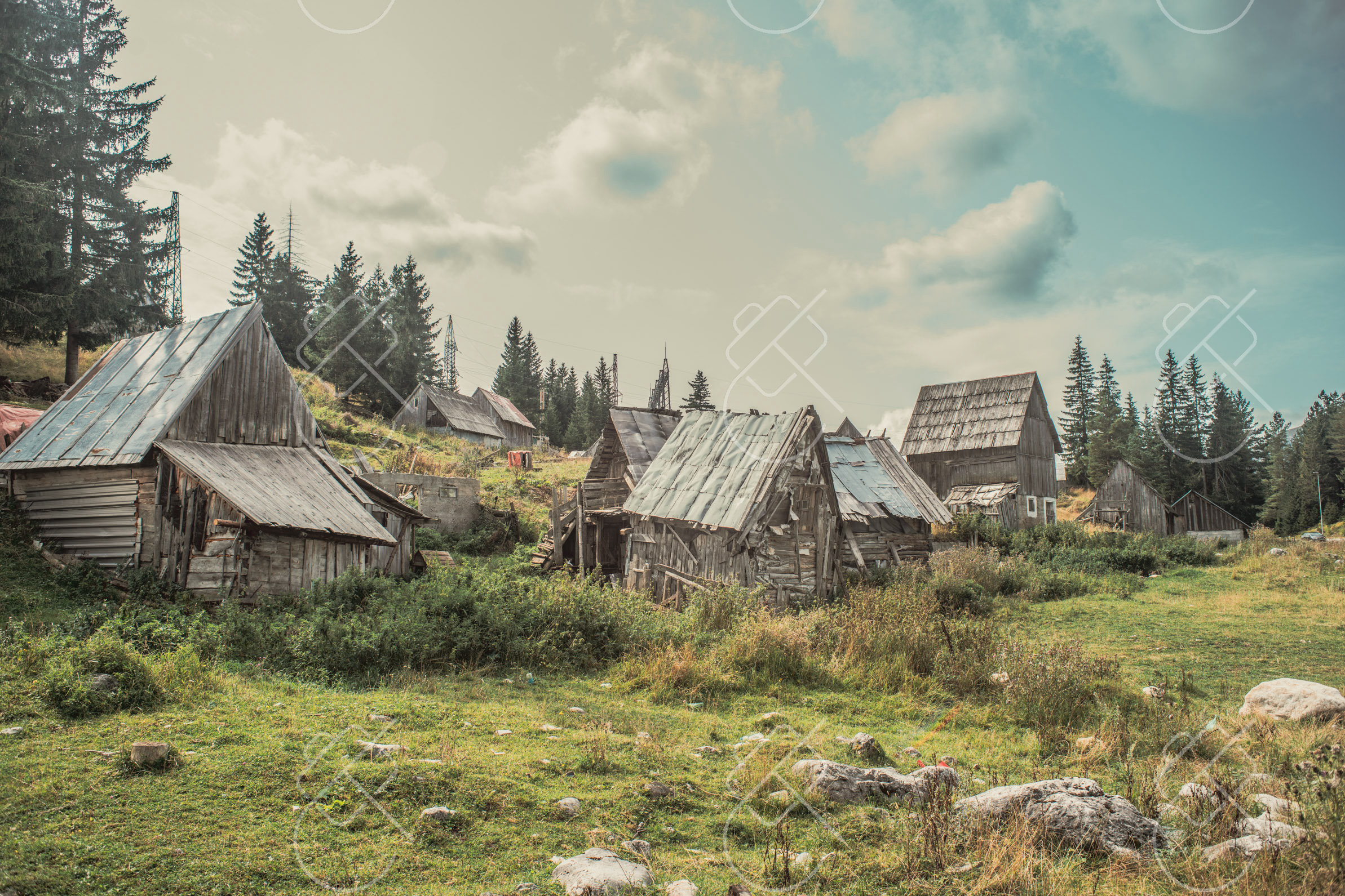 A cluster of timber katun huts in the summer grazing pastures — Nikšić to Piva and the Durmitor Ring, fine art travel photography print available from Clever Tourists