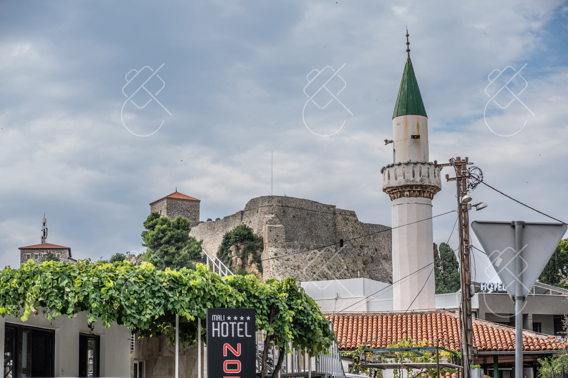 A green-capped minaret below the walls of the Old Town — Ulcinj, fine art travel photography print available from Clever Tourists