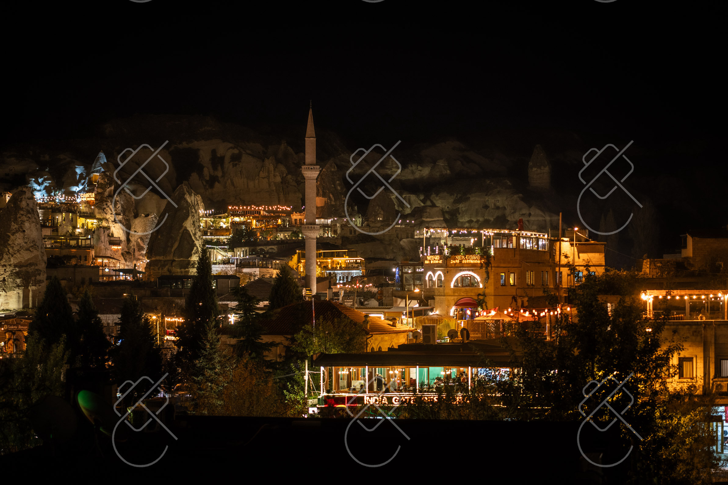 Göreme after dark, minaret lit against the hills — Göreme, fine art travel photography print available from Clever Tourists
