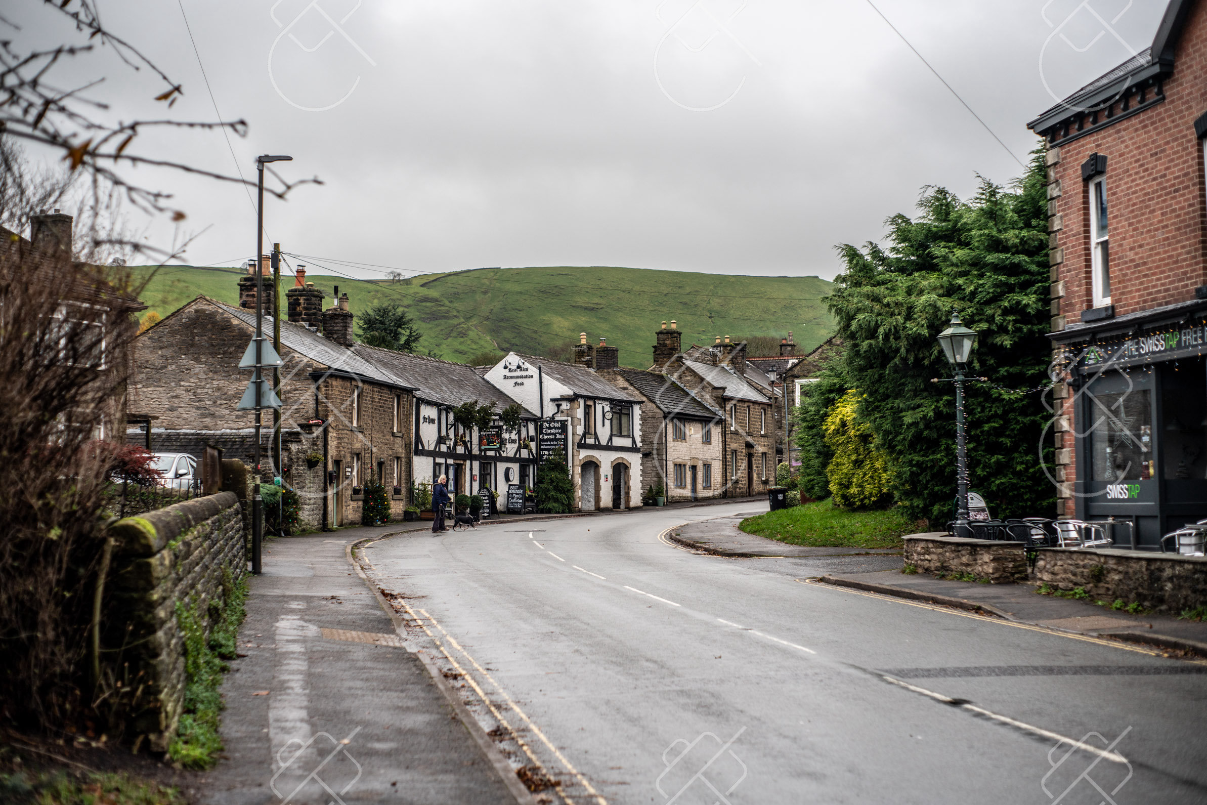Castleton's Market Place and stone cottages, hills rising directly behind the village — Castleton, fine art travel photography print available from Clever Tourists