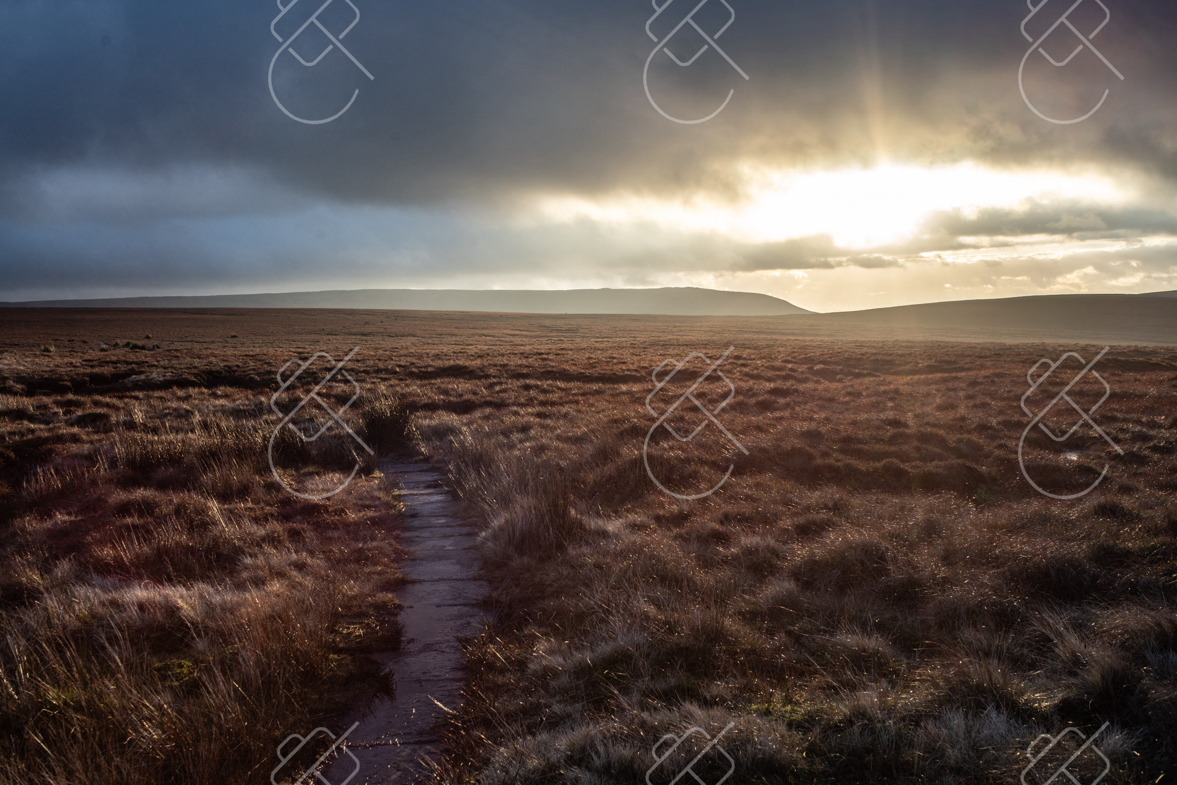 A moorland walking path above Castleton, low sun breaking through storm clouds — Castleton, fine art travel photography print available from Clever Tourists